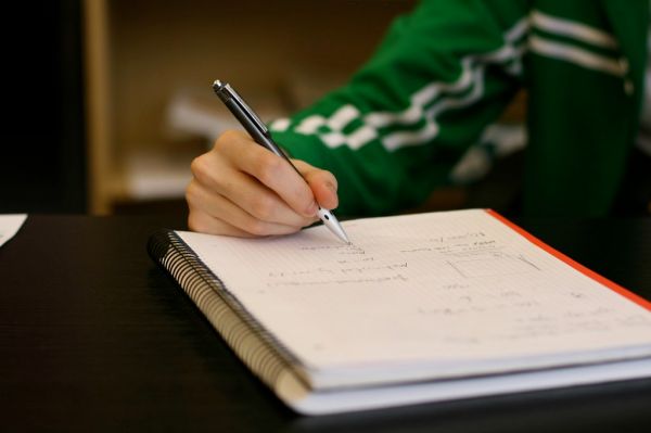 ノートにアイデアを書き出す作業机